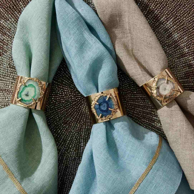 Crystal Quartz napkin rings in indigo, seafoam, and taupe on coordinating napkins