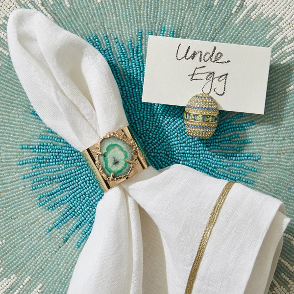 Quartz green napkin rings by Joanna Buchanan styled on a beaded placemat