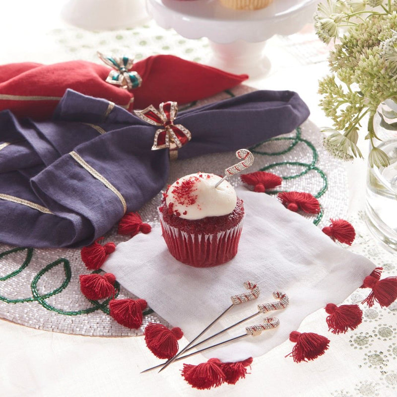 Holiday table with red and green enamel bow napkin rings by Joanna Buchanan on festive napkins