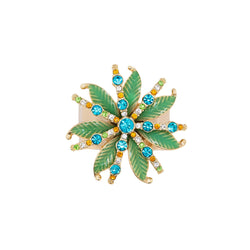 Close-up palm tree and coloured crystals on napkin ring by Joanna Buchanan.