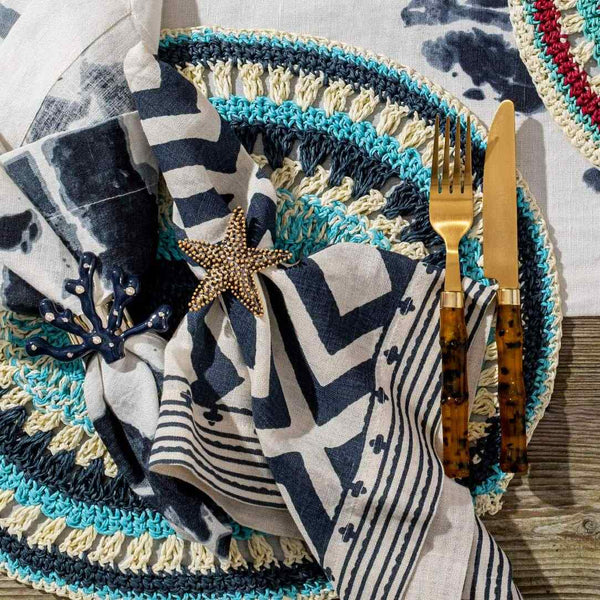 Coastal table setup with Starfish Napkin Ring by Joanna Buchanan in navy, turquoise, and white palette