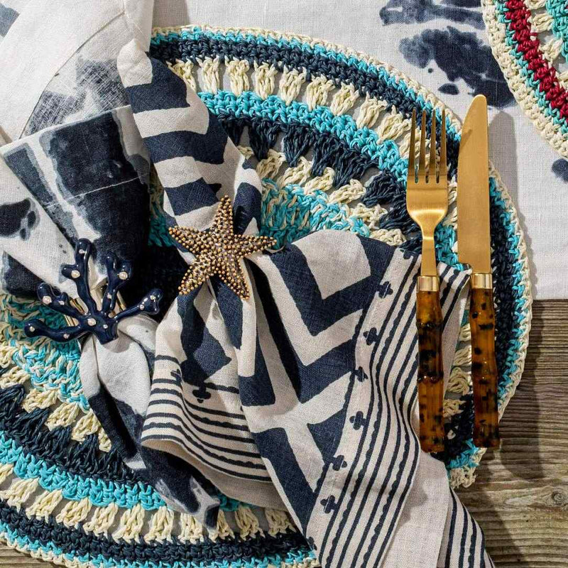 Coastal table setup with Starfish Napkin Ring by Joanna Buchanan in navy, turquoise, and white palette