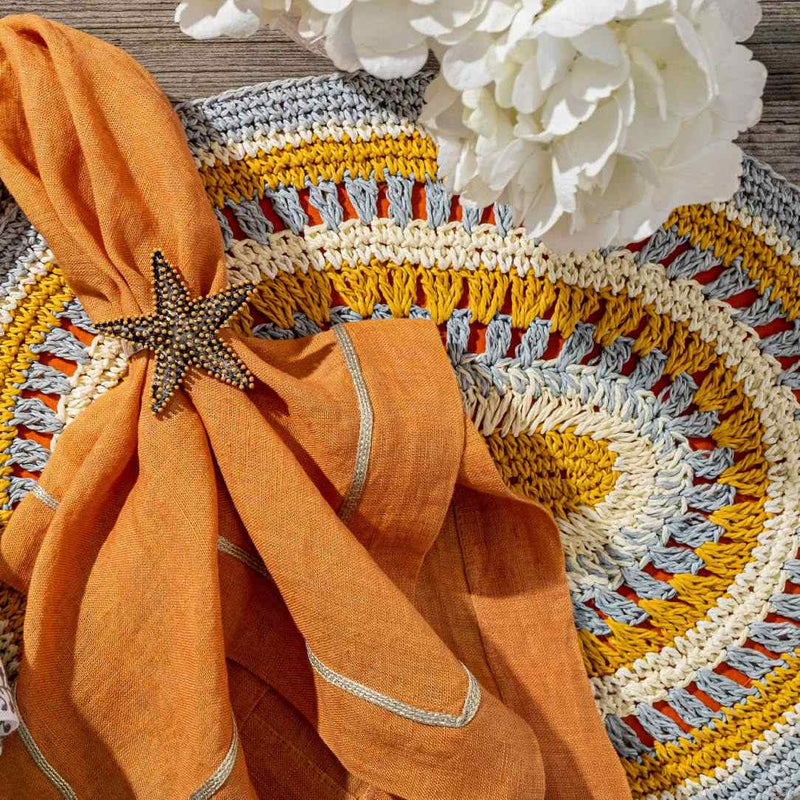 Nantucket Starfish Napkin Ring styled in a beach-themed table setting with orange hues and summery accents