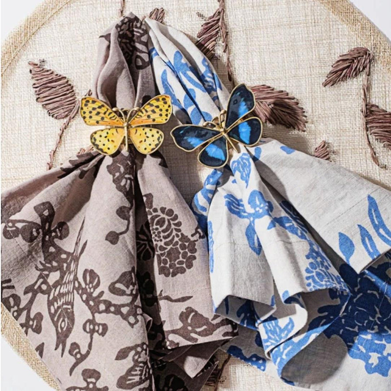 Yellow and blue Butterfly Napkin Rings by Joanna Buchanan on beige and brown napkins
