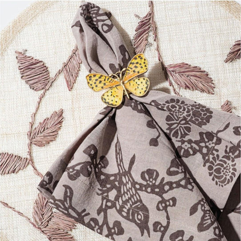 Yellow Butterfly Napkin Ring by Joanna Buchanan on brown napkin, styled in an earthy, nature-inspired table setting