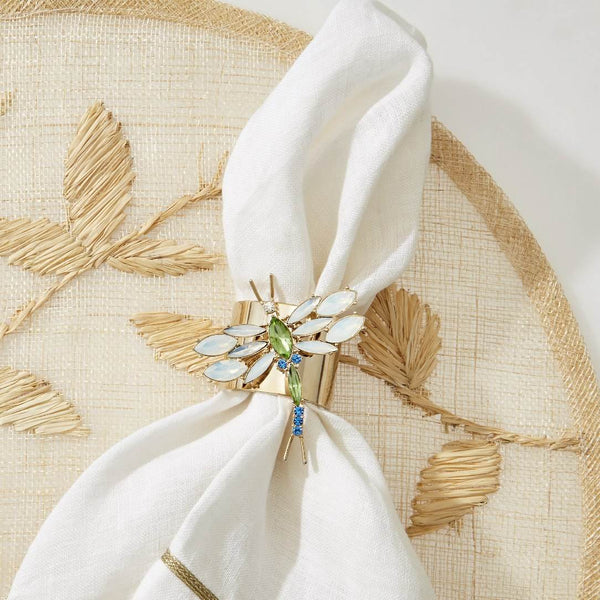 Natural palm frond round placemat with straw-like texture by Joanna Buchanan styled with dragonfly napkin ring.