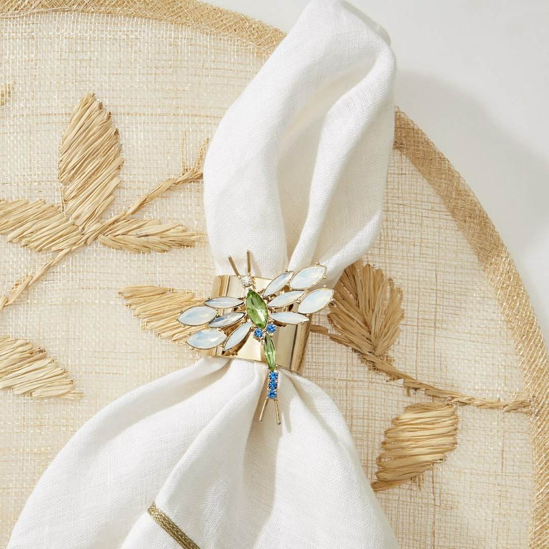 Natural palm frond round placemat with straw-like texture by Joanna Buchanan styled with dragonfly napkin ring.