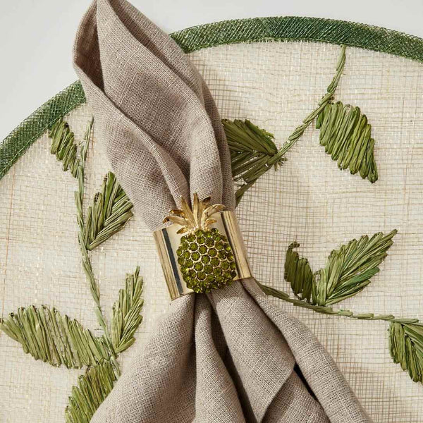 Green palm frond straw leaf placemat by Joanna Buchanan with pineapple napkin ring.