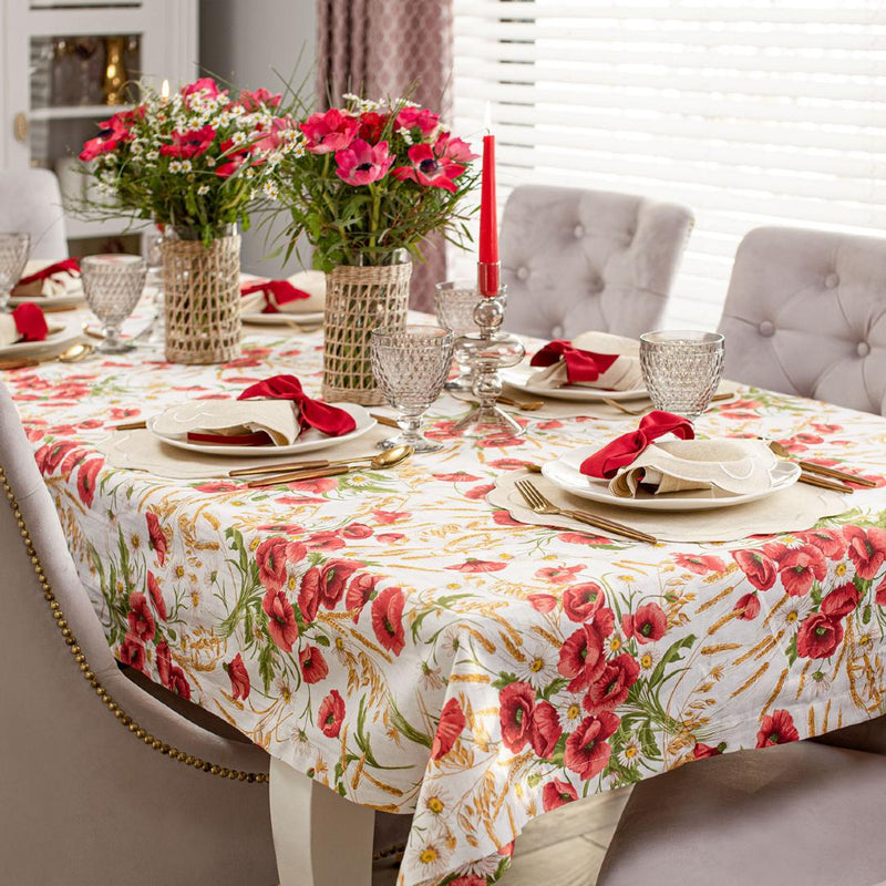 Elegant table with poppy-print tablecloth and red velvet bows as napkin rings