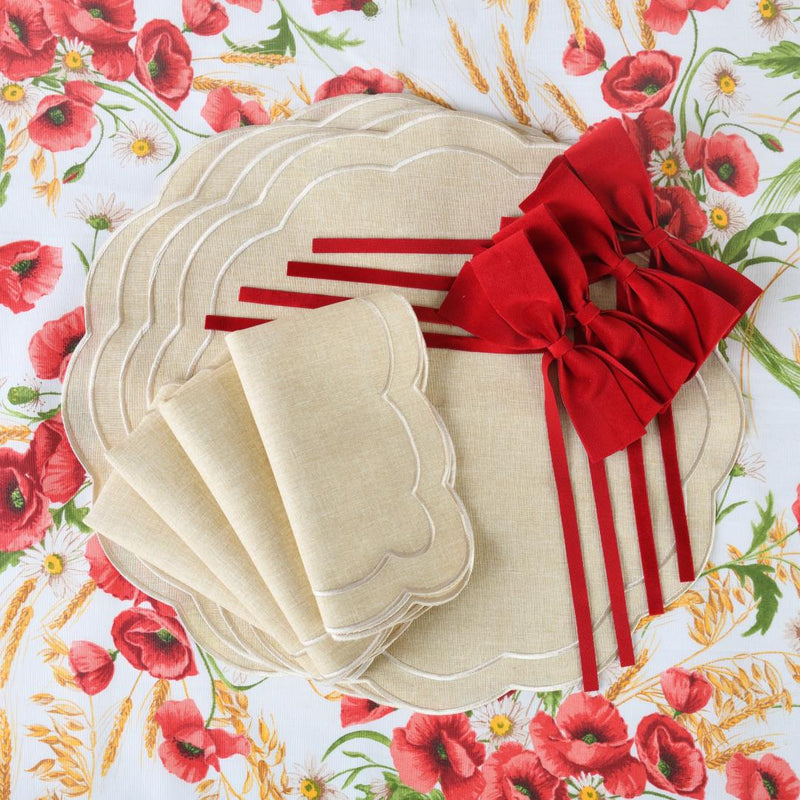 Red velvet bows around natural napkins on a summer table
