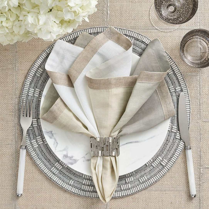 Gray and silver dip dye napkin by Kim Seybert styled with silver napkin ring, sold at Amiramour.