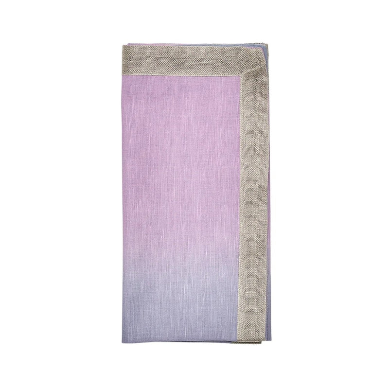 Ombre napkin in lilac and periwinkle folded on white background.