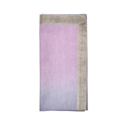 Ombre napkin in lilac and periwinkle folded on white background.