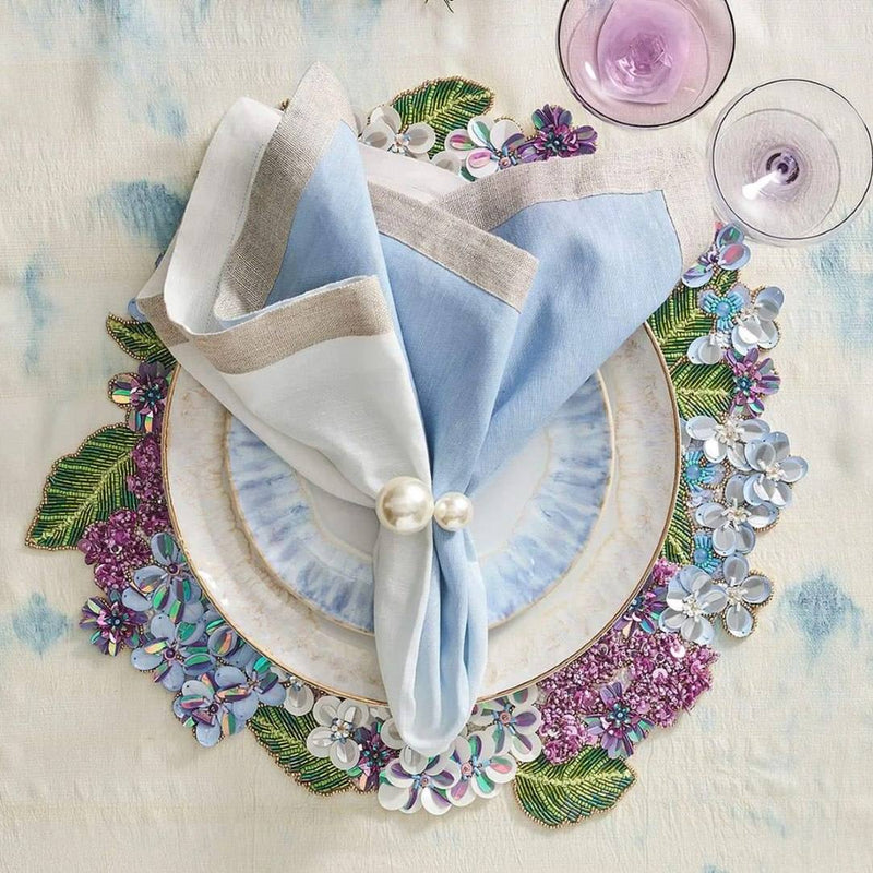 White-to-periwinkle ombré napkin styled on a summer table setting with floral placemat