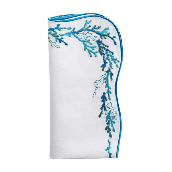 Folded Reef napkin in white with turquoise and gold embroidery by Kim Seybert, set of four.