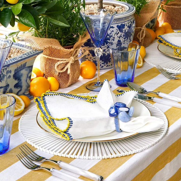 Side view of Knotted Edge napkin with colorful trim on summer table setting, Amiramour