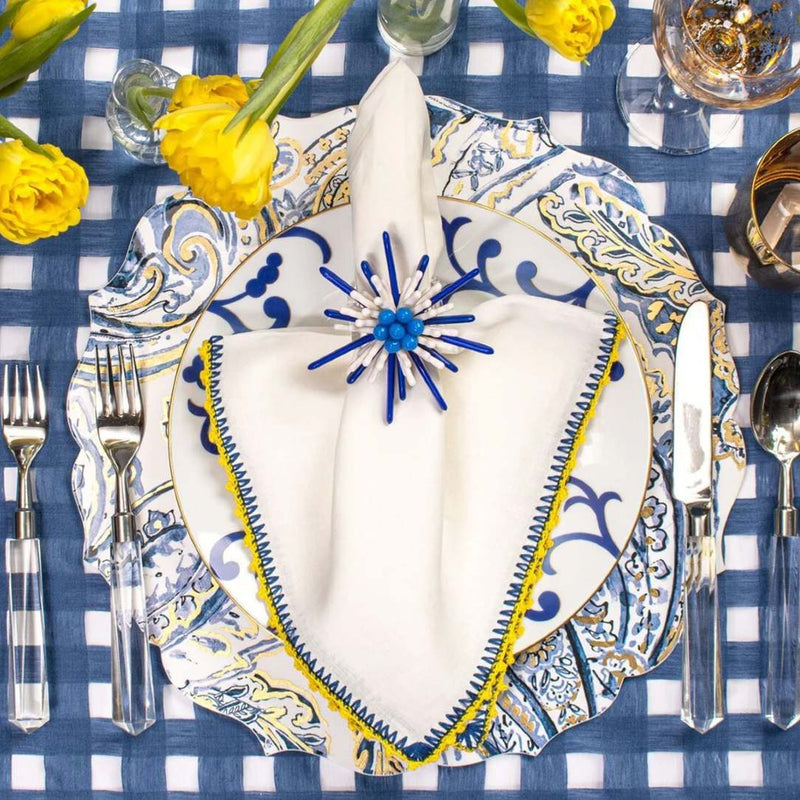 Top view of Knotted Edge napkin with vibrant blue and yellow edging, sold by Amiramour