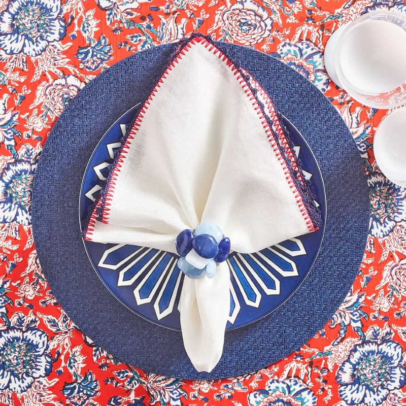 Top view of Knotted Edge napkin with navy and red crochet edging, styled with napkin ring, Amiramour