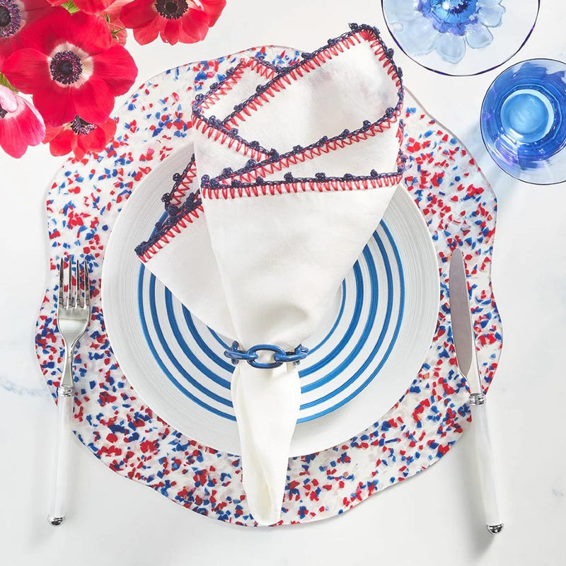 Top view of Knotted Edge napkin with navy and red crochet edging, styled with napkin ring, Amiramour