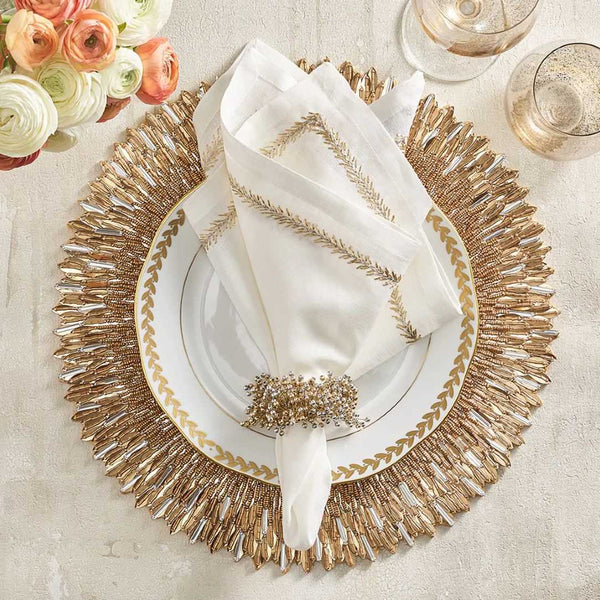 Top view of Jardin linen napkin styled with gold napkin ring and placemat by Amiramour