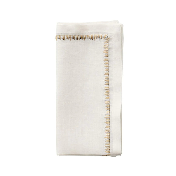 Filament napkin in white with gold and silver embroidery by Kim Seybert on white background