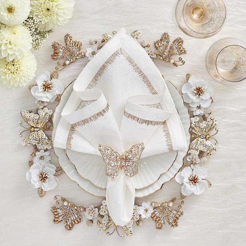 Styled Filament linen napkin in white with gold and silver embroidery by Kim Seybert