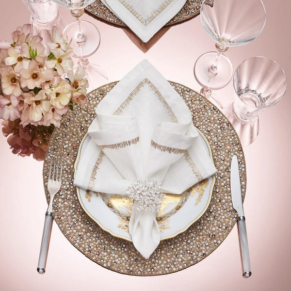 Filament White Linen Napkin with Embroidery by Kim Seybert styled with clear napkin ring