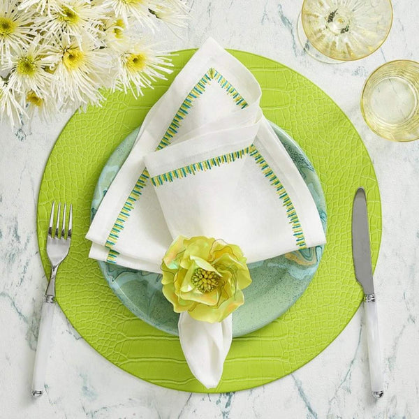 Top view of Kim Seybert’s Filament napkin with floral ring and lime placemat, sold by Amiramour