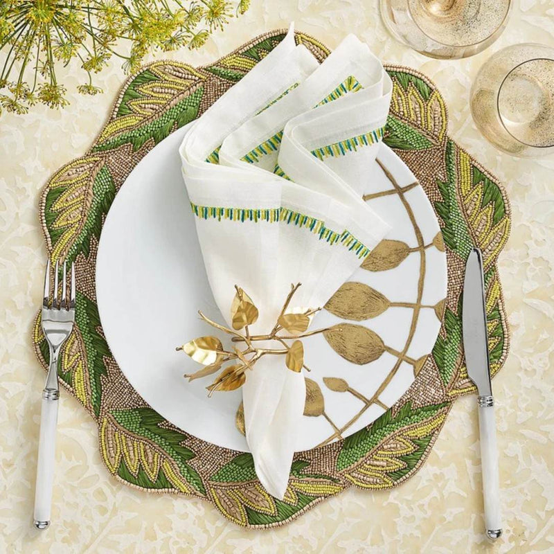 Top view of the Filament napkin in white, yellow and green styled with gold napkin ring, sold by Amiramour 