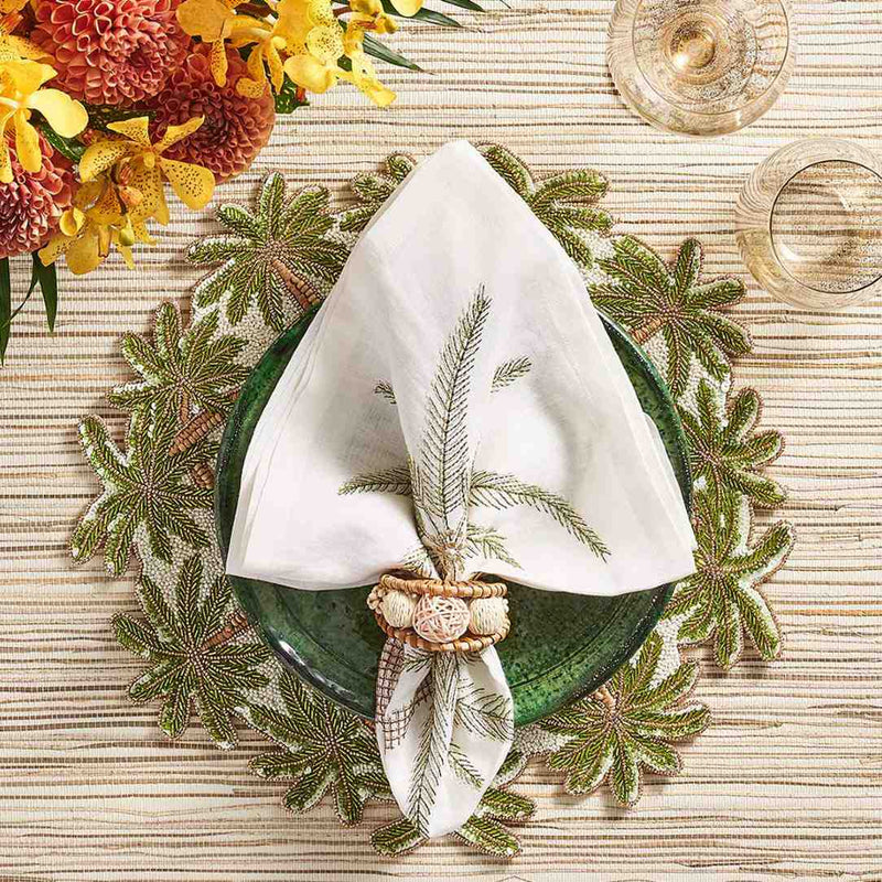 Kim Seybert Palm Coast napkin on a refined seaside table with palm tree accents