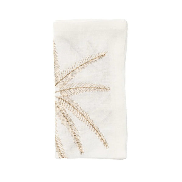 Folded Palm Coast napkin in white linen with gold and natural palm embroidery by Kim Seybert, shown at Amiramour