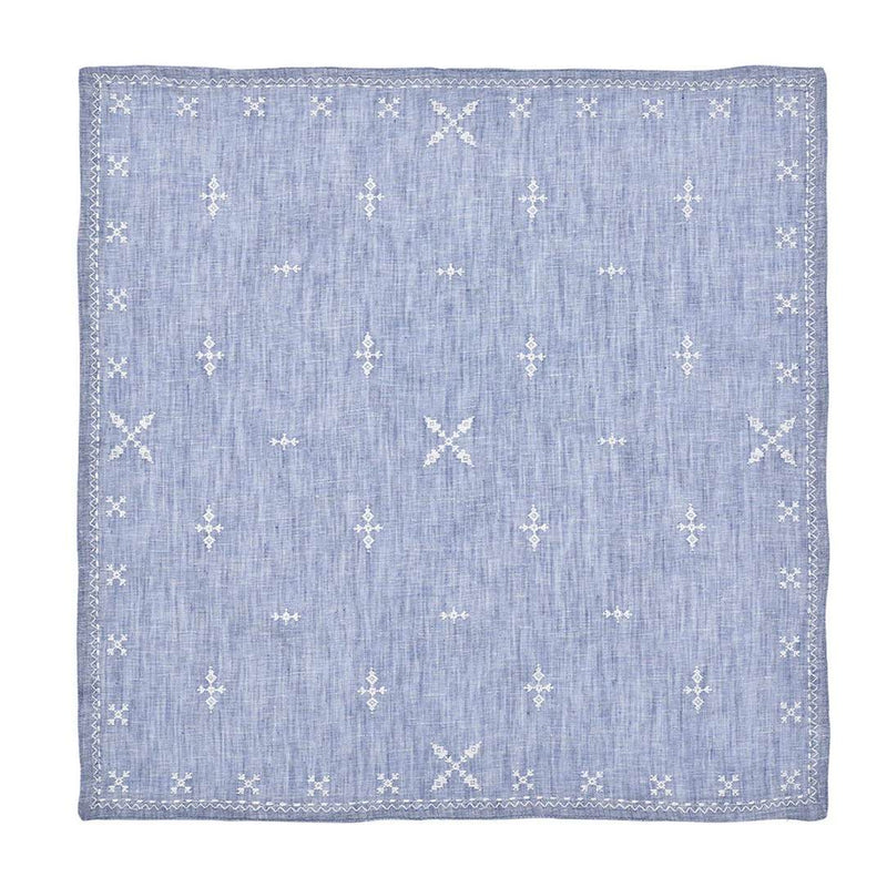 Unwraped Fez linen napkin in blue with white embroidered Moroccan motifs by Kim Seybert, sold at Amiramour