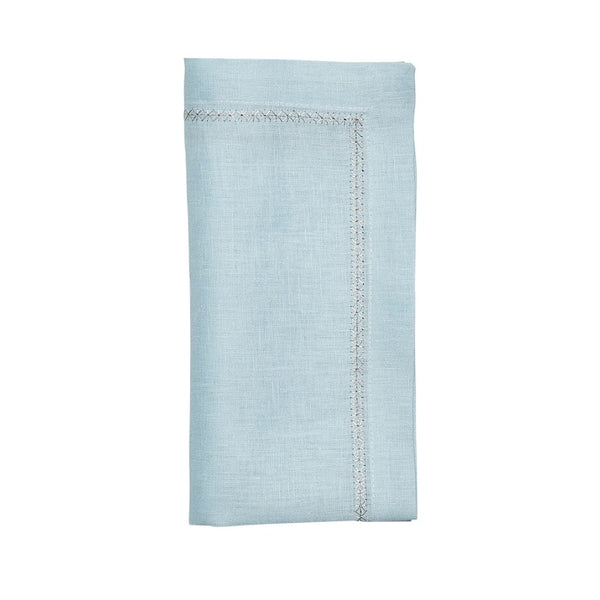 Folded sky blue linen napkin with embroidered star border on white background, sold at Amiramour