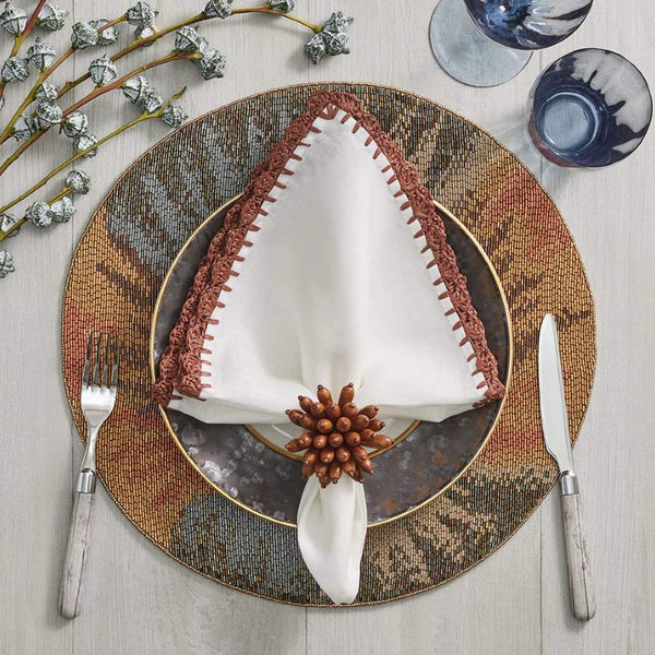 Top view of Shell Edge Napkin by Kim Seybert with beaded ombré placemat, sold by Amiramour