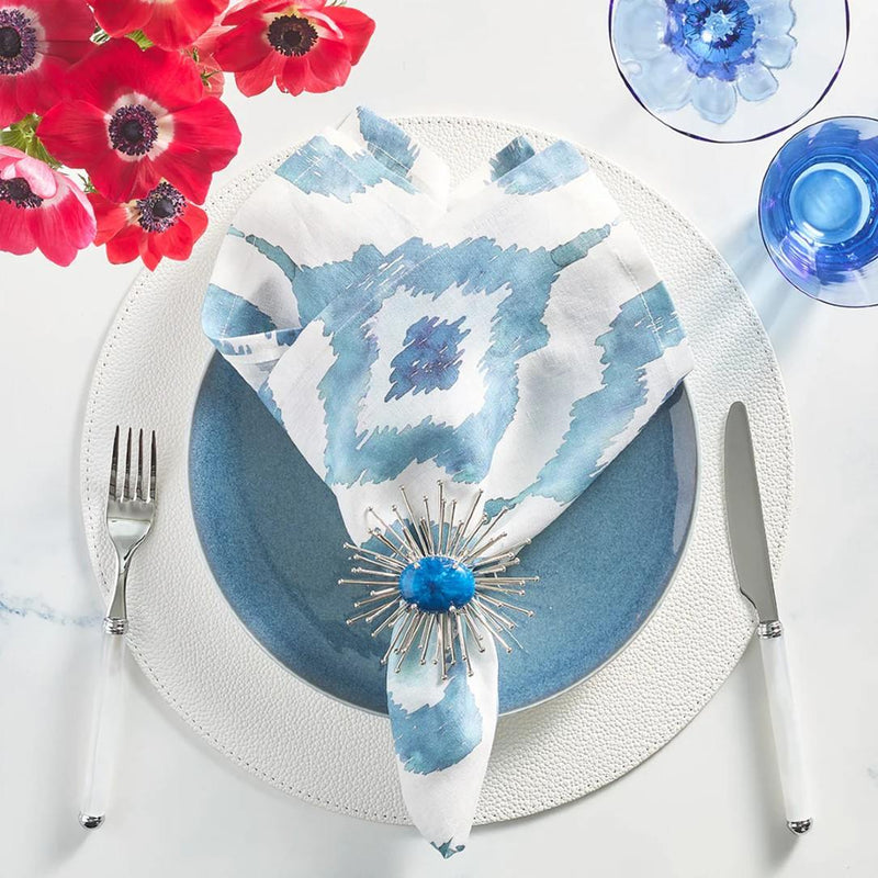 Styled Blue Watercolor Ikat linen napkin by Kim Seybert with modern silver and blue napkin ring.