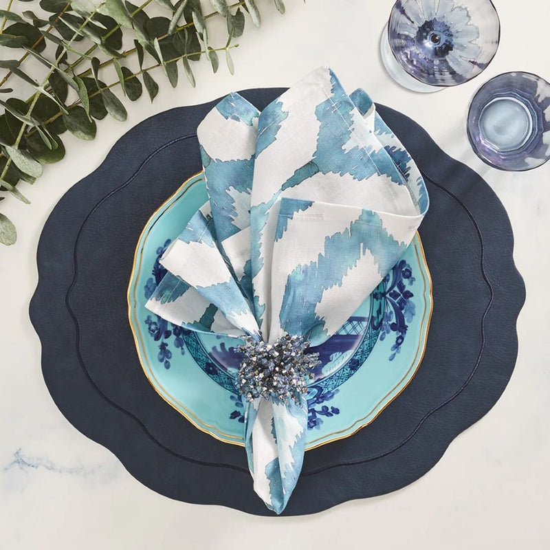 Styled Blue Watercolor Ikat linen napkin by Kim Seybert with shiny blue napkin ring, sold at Amiramour.