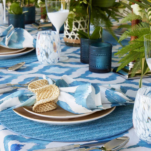 Styled Blue Watercolor Ikat linen napkin by Kim Seybert on coastal tropical table setting, sold at Amiramour.