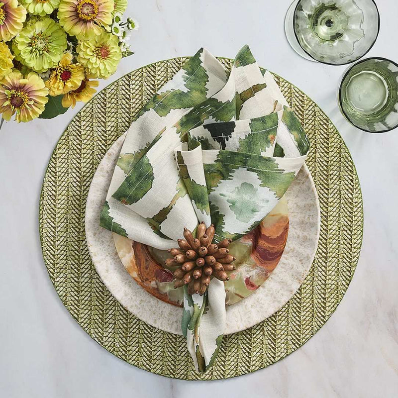 Olive green Watercolor Ikat napkin by Kim Seybert, styled on rattan green placemat, sold at Amiramour.