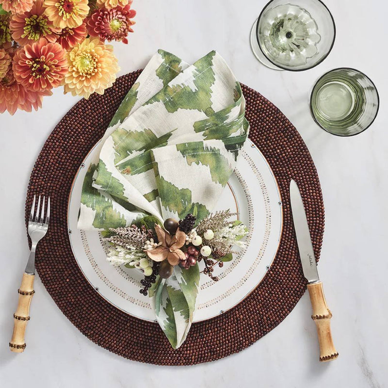 Olive green Watercolor Ikat napkin by Kim Seybert, styled on brown autumn table setting, sold at Amiramour.