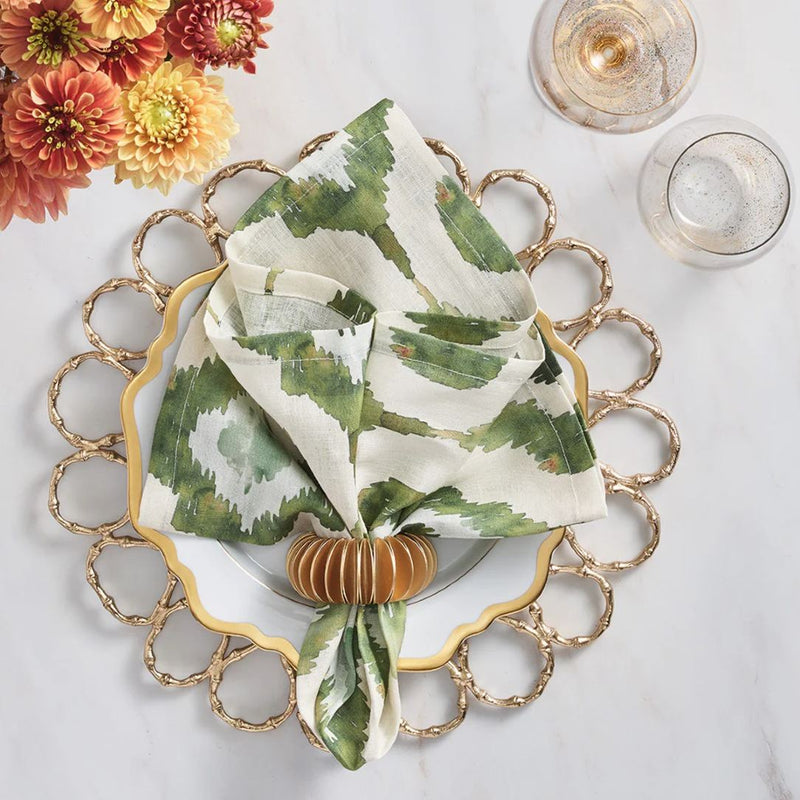 Olive green Watercolor Ikat napkin by Kim Seybert, styled on gold plate charger, sold at Amiramour.