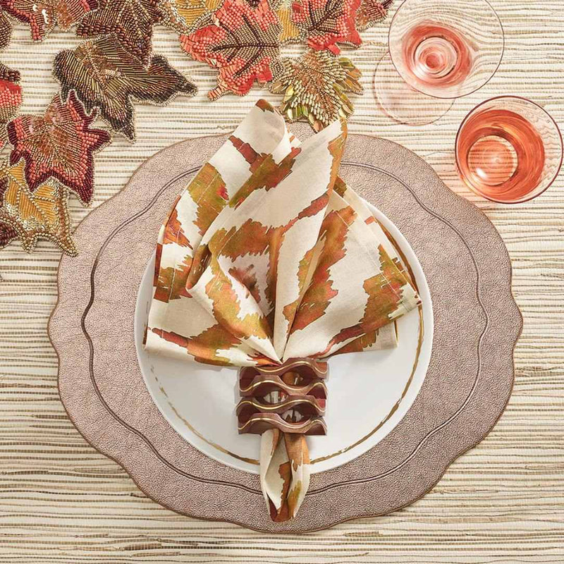 Rust orange Watercolor Ikat napkin by Kim Seybert, styled on autumn table setting, sold by Amiramour.