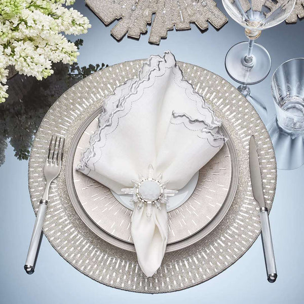 Top view of Arches napkin styled with silver placemat and glam napkin ring by Amiramour