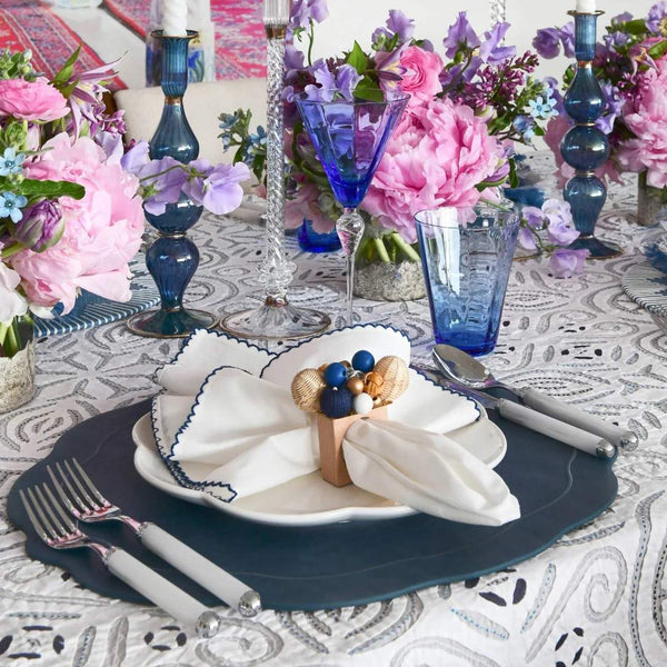 Side view of Casbah napkin with rattan ring on casual table setting, sold by Amiramour