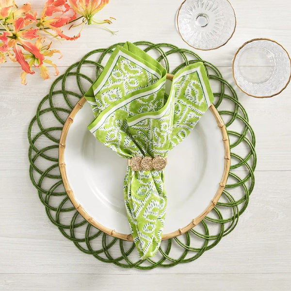 Olive green Alfresco cotton napkins by Kim Seybert, styled with rattan green placemat, sold at Amiramour.