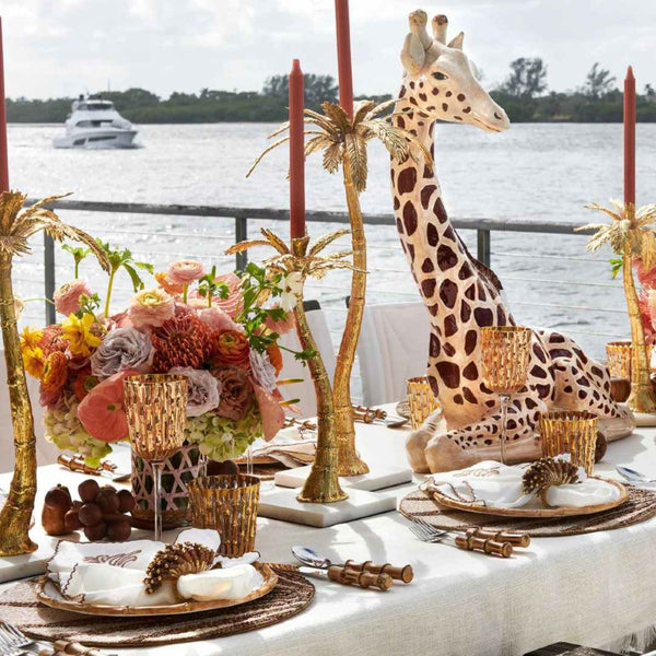 Royal Palm napkin styled with beaded placemat and soft neutrals on a refined tropical table