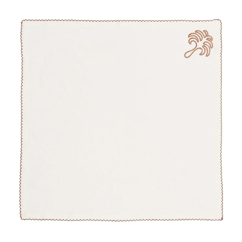Unfolded Royal Palm napkin in white with embroidered palm leaf design and stitched border, displayed at Amiramour