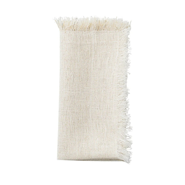 Folded Fringe napkin in white linen with gold lurex threads and fringe edge by Kim Seybert, available at Amiramour