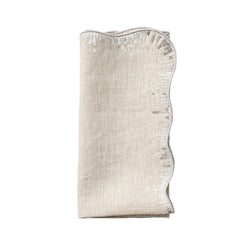 Folded Sequin Spray napkin in natural linen with silver sequin embroidery on white background sold by Amiramour