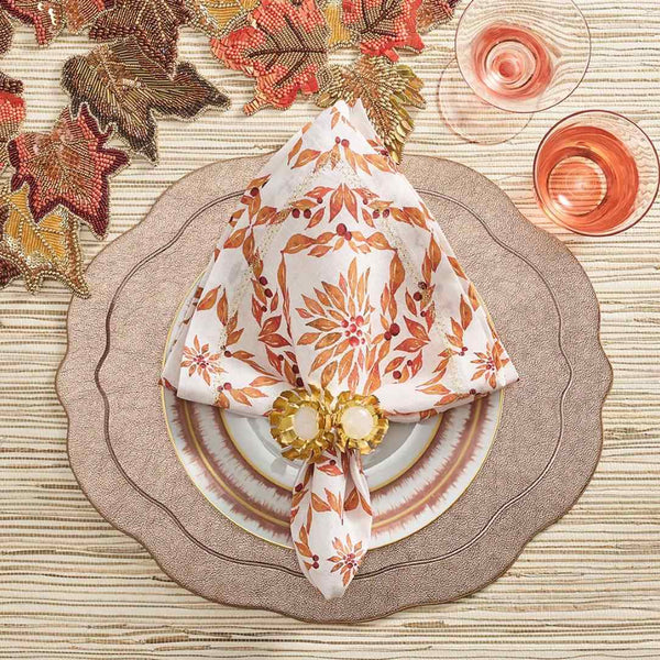 Laurel linen napkin with hand-painted foliage in warm tones styled on autumn table setting.