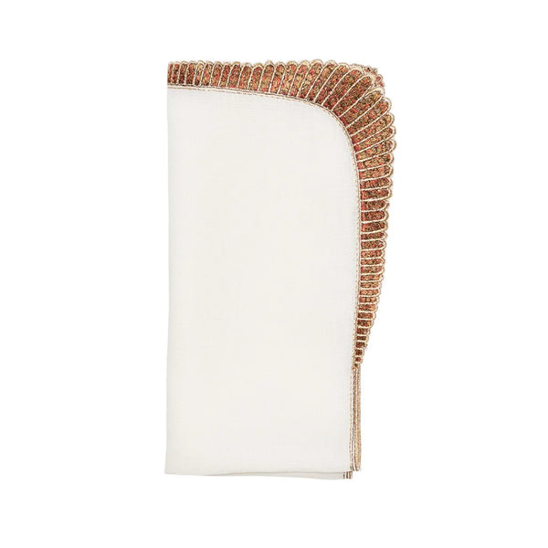 Folded Nile napkin in white linen with bronze scarab-inspired embroidery by Kim Seybert, available at Amiramour